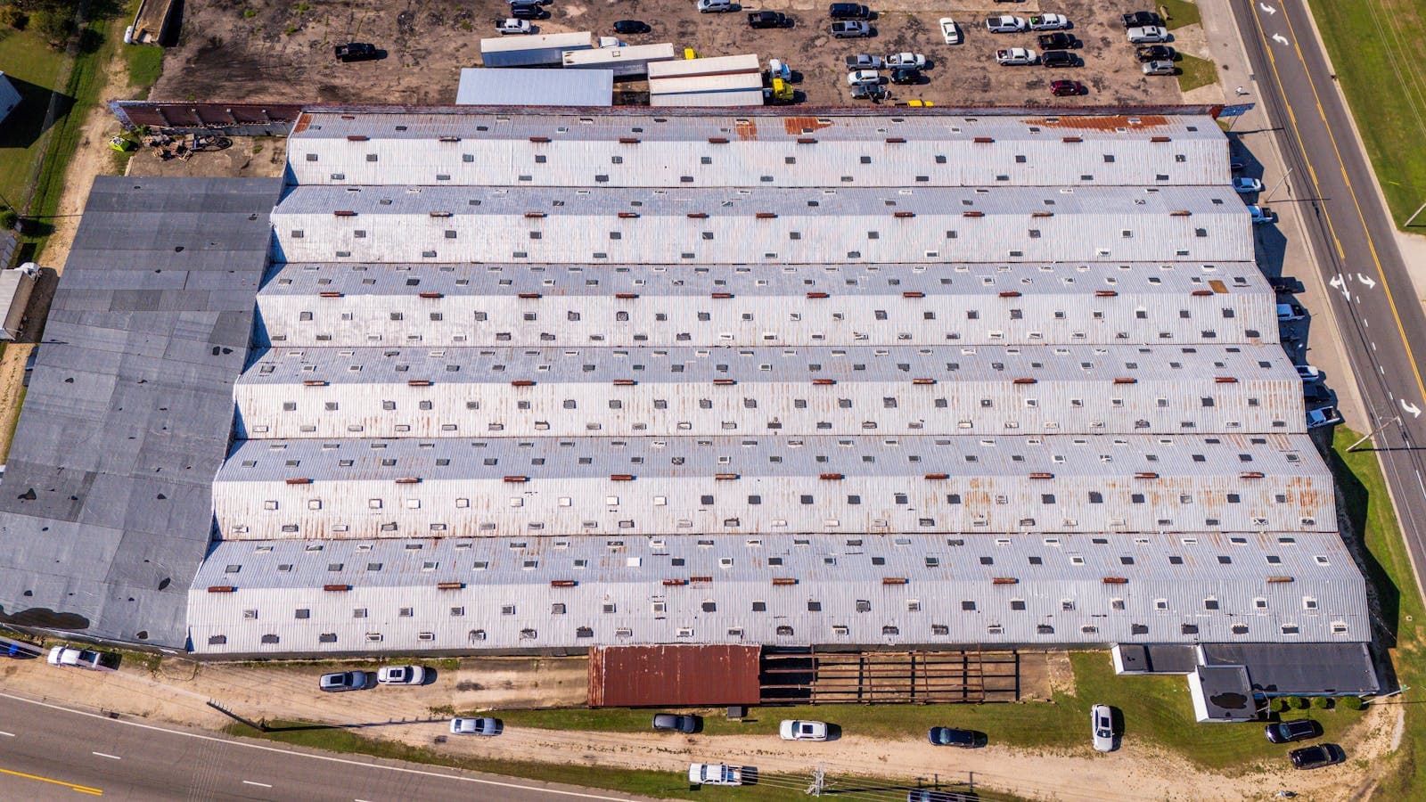 Wide shot of commercial building roofline with HVAC and rooftop access