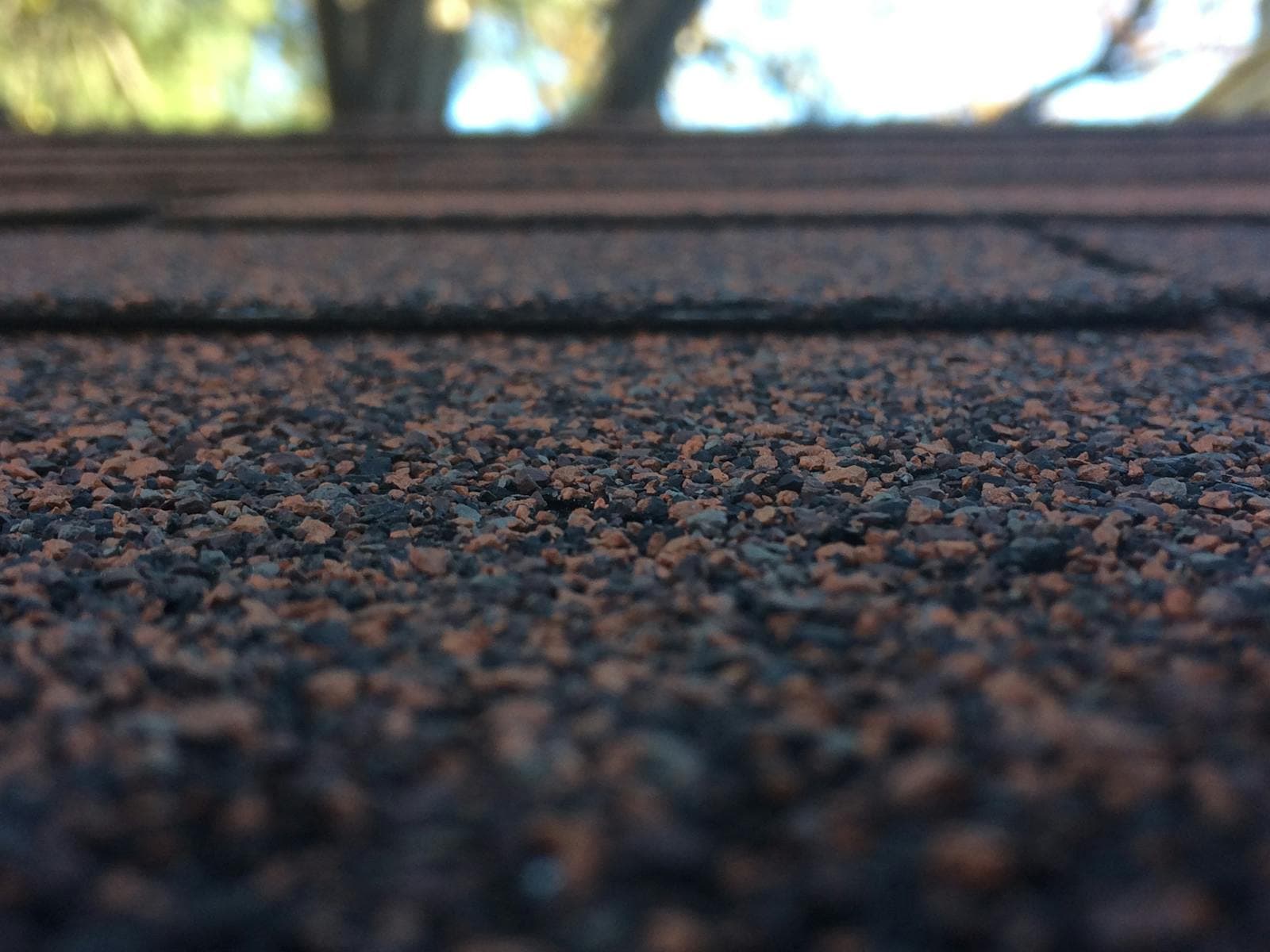 Close-up texture of architectural asphalt shingles on a new roof