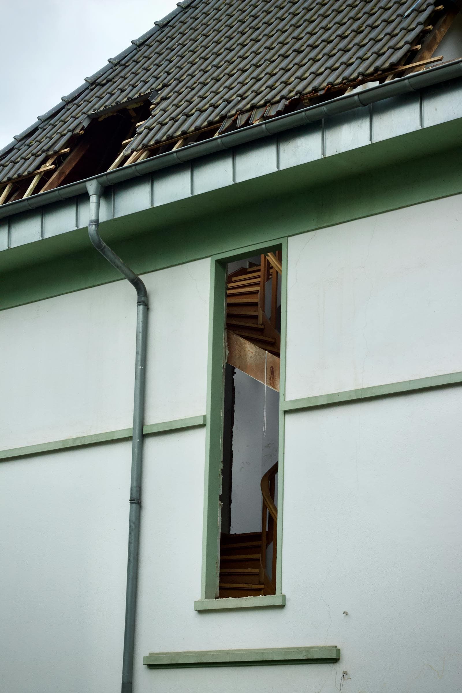 Roof with storm damage and debris after a severe weather event